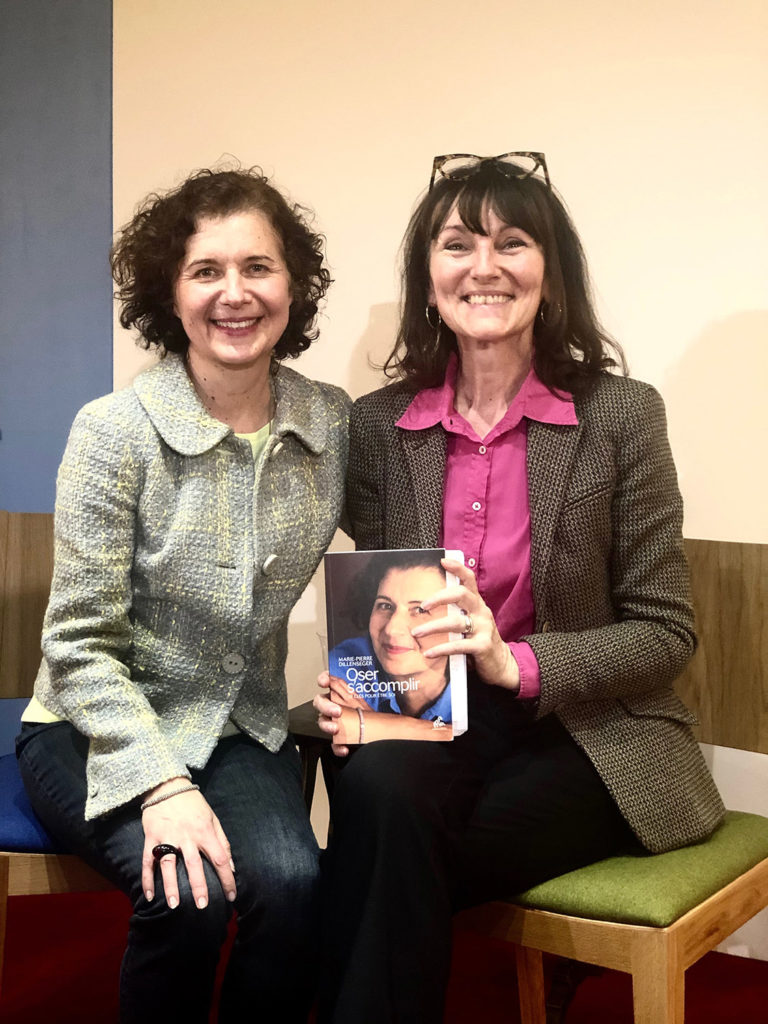 Marie-Pierre Dillenseger et Marie-aurence Cattoite sont assises cote à cote et ergardent l'objcetf en souriant. Marie-Laurence teiet dans ses mains le livre de Marie-Pierre "Oser s'accomplir"